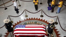 A Vietnamese group from Orange County, Calif., pays their respects near the casket of Sen. John McCain during a viewing at the Arizona Capitol on Wednesday, Aug. 29, 2018, in Phoenix.
