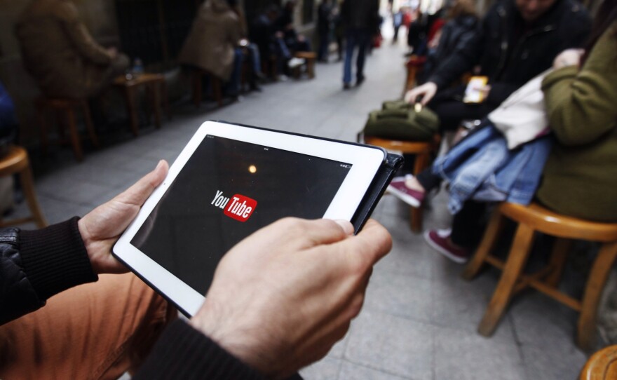 A man tries to get connected to YouTube with his tablet at a cafe in Istanbul on Thursday.
