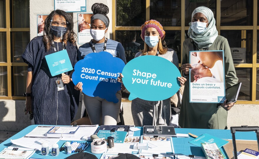 U.S. Census Bureau workers promote the national head count outside of Sylvia's Restaurant in New York City's Harlem neighborhood.