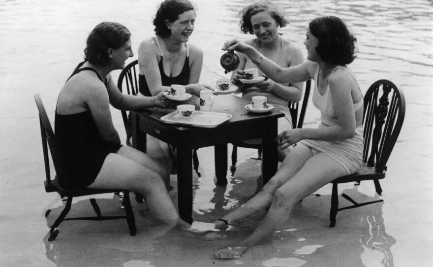 A group of women having tea in a swimming pool at Hornsey from July 1935.