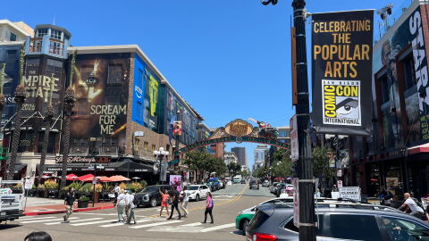 People walk around the Gaslamp District in downtown San Diego, where buildings are dressed up for Comic-Con on July 22, 2025.