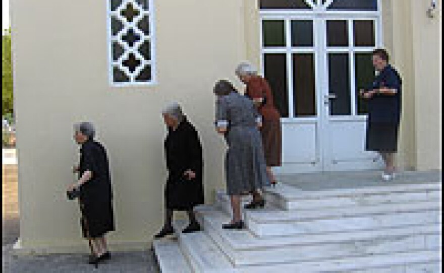 Women leave the Byzantine Greek Orthodox church in the center of the village. Only 160 people live in Avdou year-round, and the majority of the population is elderly in age.