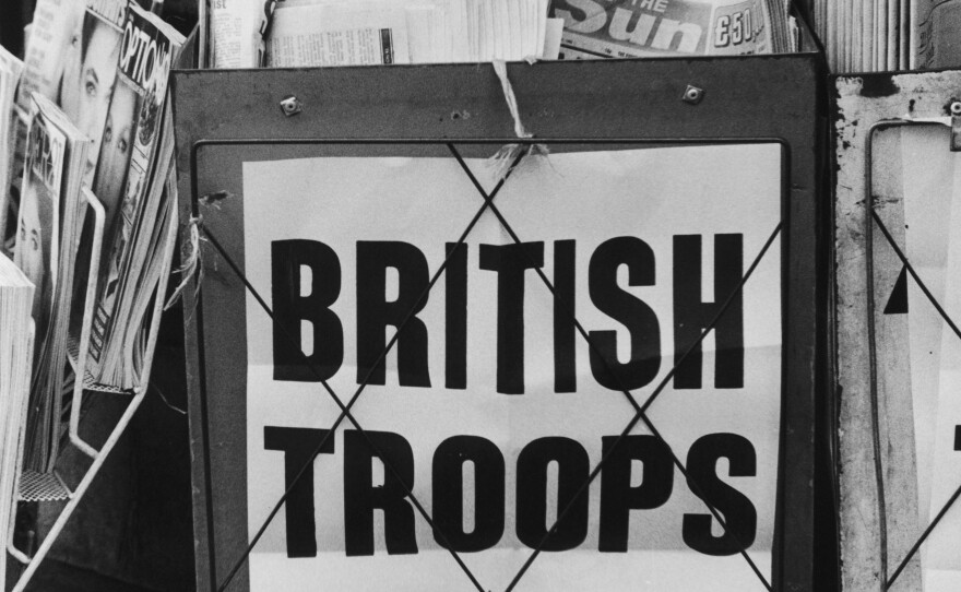 An<em> Evening Standard</em> headline on a London newspaper stand in May 1982 reads, 'British Troops Go In'.