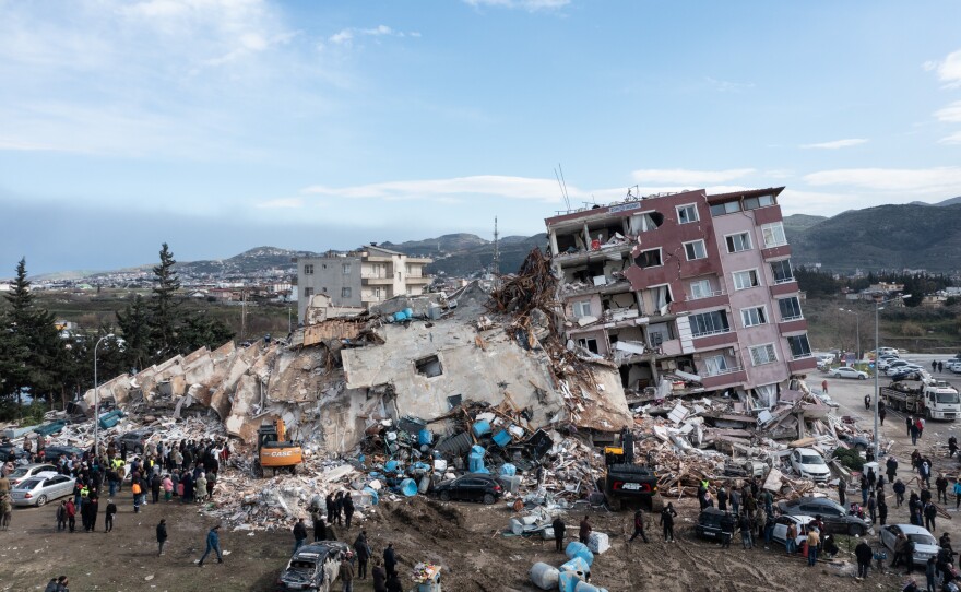 Rescue workers work at the scene of a collapsed building in Hatay, Turkey on Tuesday. The earthquake and aftershocks caused widespread destruction in southern Turkey and northern Syria and were felt in nearby countries.