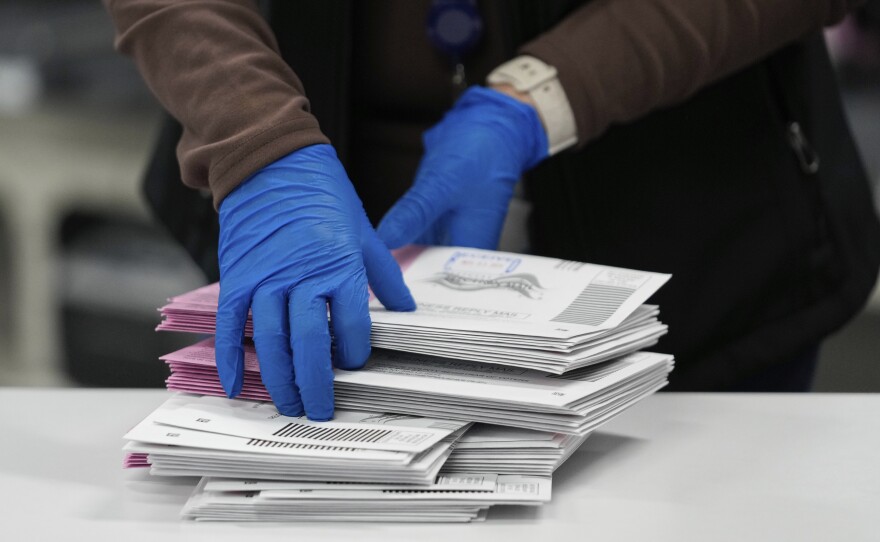 An election worker sorts mail-in ballots in Reno, Nev., on Nov. 5, 2024.