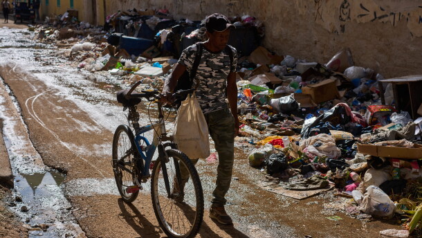 A man pushes his bicycle along a trash-strewn street in Havana, Cuba, Tuesday, June 9, 2026.