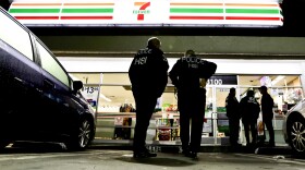 U.S. Immigration and Customs Enforcement agents serve an employment audit notice at a 7-Eleven convenience store Wednesday, Jan. 10, 2018, in Los Angeles. 
