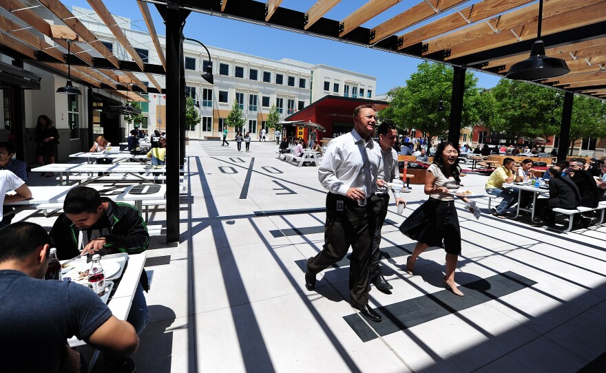 People walk into the cafeteria at Facebook's main campus in Menlo Park, Calif., May 15, 2012.