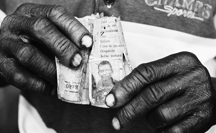 These hands belong to a 67-year-old man who's lived in the Dominican Republic for over 50 years — one of the thousands of people of Haitian descent who are stateless. Constantine learned that a company ID card, issued decades ago, is the man's only piece of identification.