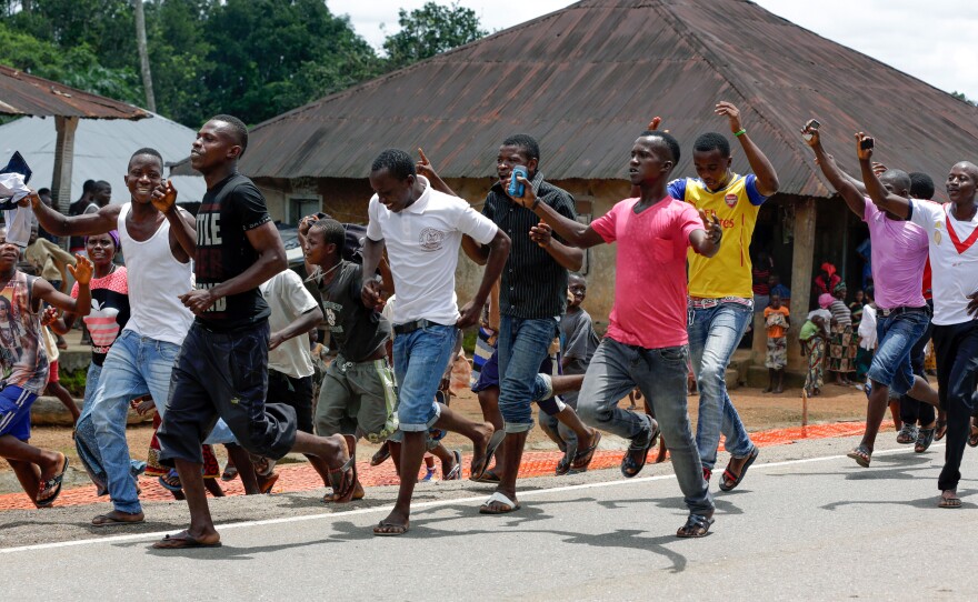 A celebration erupts in the streets of the Massessehbeh village on Friday, after President Ernest Bai Koroma officially ended Sierra Leone's largest remaining Ebola quarantine.