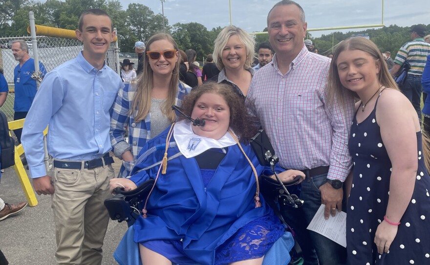 The Ratcliff family, including Alexis' sister Apple (right), celebrates with Alexis at her high school graduation.