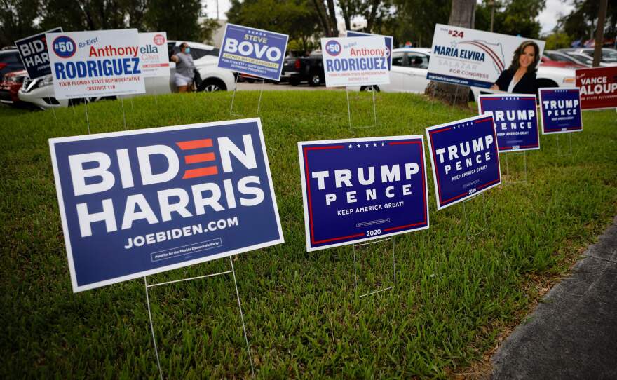 Campaign signs are seen at Westchester Regional Library in Miami on Oct. 19.