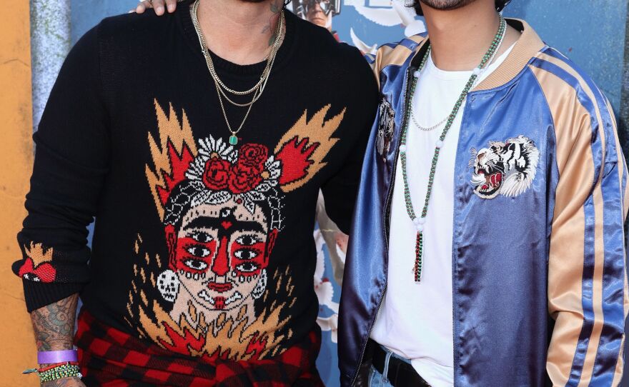 <em>Blue Beetle</em> director Angel Manuel Soto and star Xolo Maridueña.