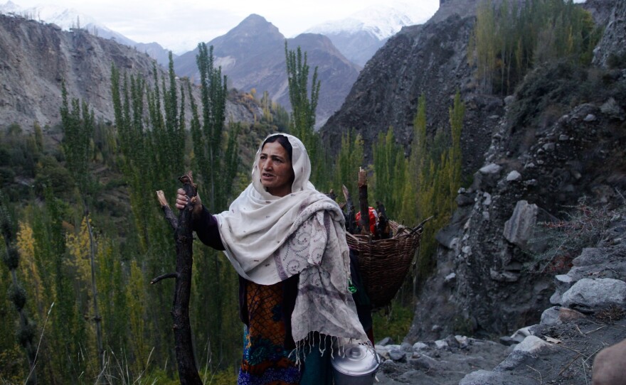 Shamim Banno, 55, walks up the Harchi Valley after she finished milking her cow. Farmers in the Harchi Valley in Pakistan's highlands have enjoyed a close relationship with their glacier that snakes between two mountain peaks.