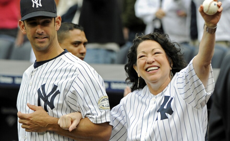 Sotomayor is escorted onto the field by New York Yankees catcher Jorge Posada to throw out the ceremonial first pitch before the New York Yankees game against the Boston Red Sox on Sept. 26, 2009 at Yankee Stadium in New York.