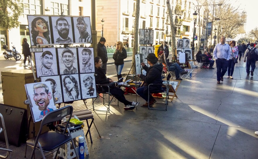 Caricaturists line Barcelona's busy tourist thoroughfare, La Rambla.