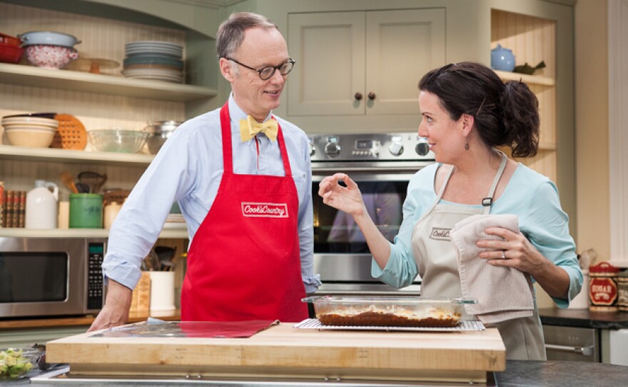 Test cook Erin McMurrer (right) shows host Christopher Kimball (left) how to make pork ragu at home.