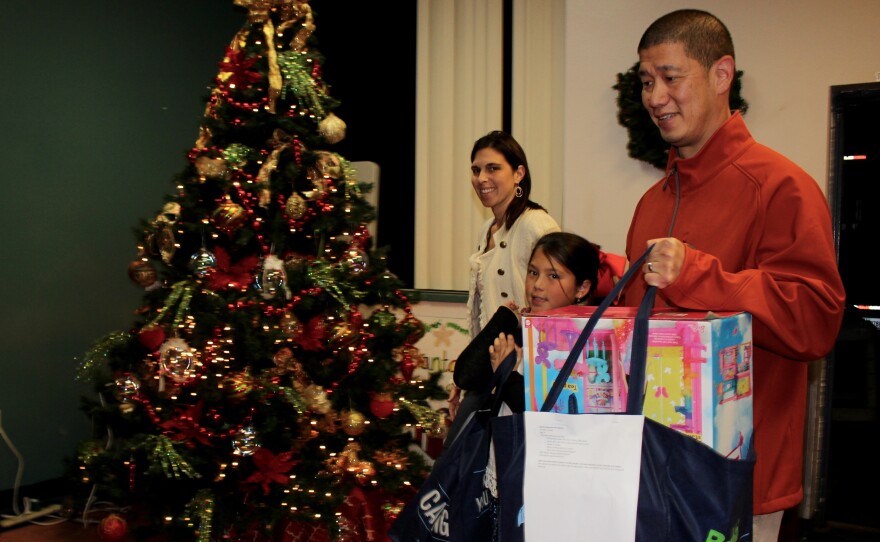 The Chou family donates gifts to an “adopted” family. From left Karissa, Ashley age 9, and Mike. At Interfaith Community Services center in Escondido, Dec. 6, 2016.
