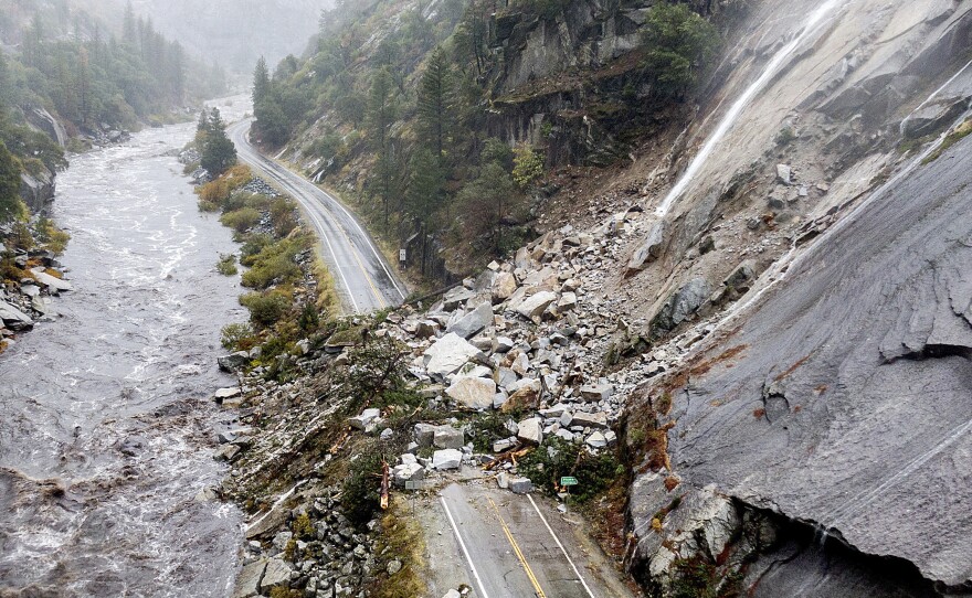 Rocks and vegetation cover Highway 70 following a landslide in the Dixie Fire zone on Sunday.