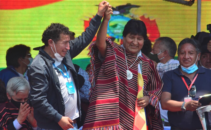 Former Bolivian President Evo Morales (middle) greets supporters during a welcoming ceremony after he crossed the border from Argentina after one year in exile on Monday, in Villazón, Bolivia.