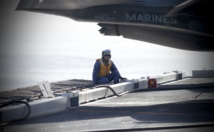 A Japanese sailor observes a F-35B prepare for launch on Nov. 6, 2024 off the coast of San Diego, Calif.