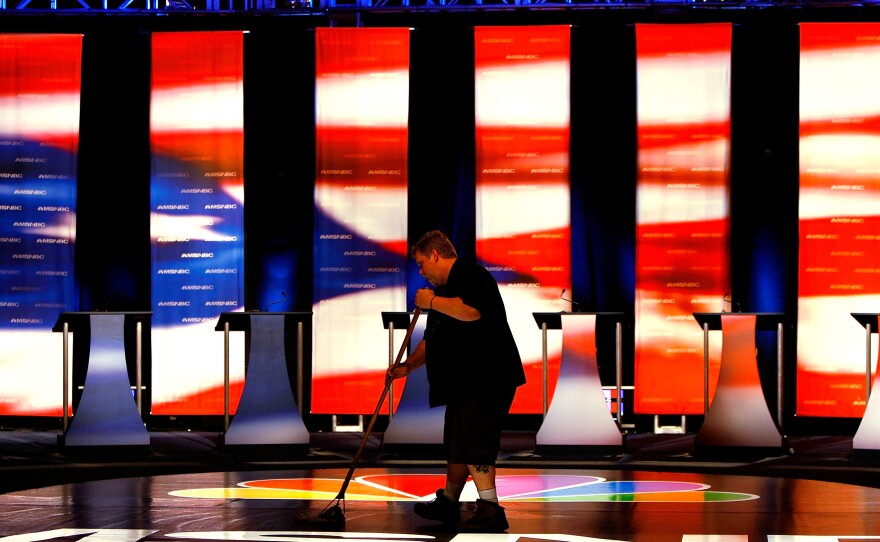 A worker sweeps the stage prior to the first Democratic presidential debate on April 26, 2007, in Orangeburg, S.C. The debate featured eight Democratic presidential candidates.