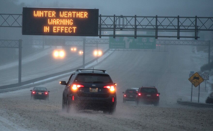 Vehicles move along Interstate 85 as an overhead sign indicates during a winter storm on Jan. 22 in Greensboro, N.C. A major snowstorm is forecasted for the East Coast this weekend with some areas getting up to 30 inches of snow.
