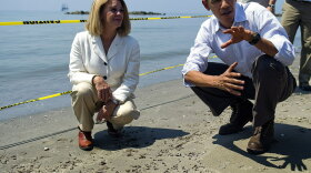 President Obama and LaFourche Parish President Charlotte Randolf look over tar balls that washed up at Louisiana's Fourchon Beach on Friday prior to a briefing on the federal government's response to the Gulf Coast oil spill.