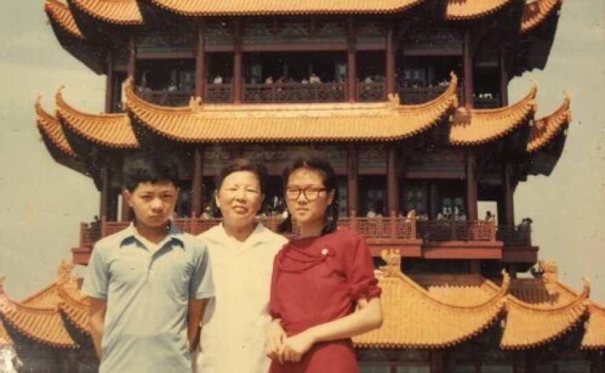 Laura Gao's mother (in the red dress) poses with her family in front of the Yellow Crane Tower in Wuhan before leaving for college in 1985. Gao visited that landmark for the first time 20 years later.