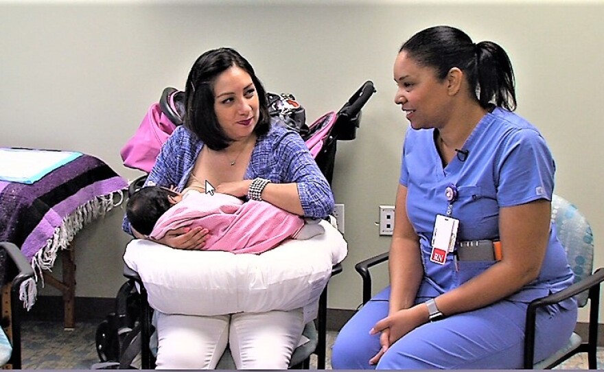 Mayra Moreno breastfeeds her daughter, Ambar, as lactation consultant Layla Fitzhugh looks on, on Sept. 2, 2016.