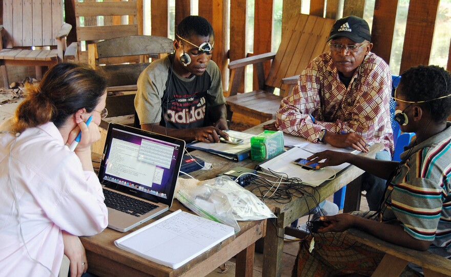 Men from the Mbenzele Pygmy ethnic group listen to Western music for the first time while an anthropologist measures their vital signs, such as heart rate and skin perspiration.