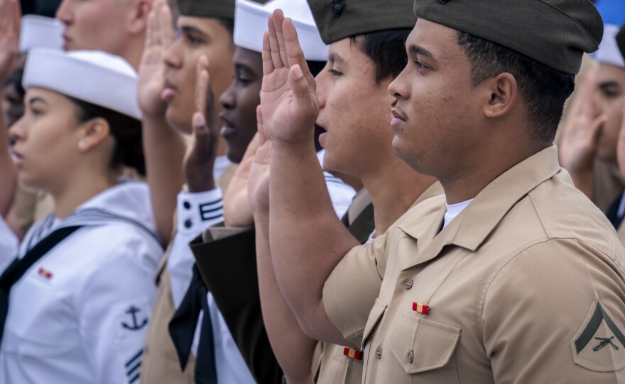 U.S. military members stand in uniform during their naturalization ceremony, July 3, 2023.