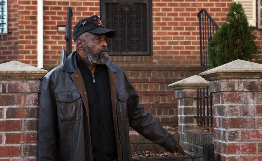 Ernest Peterson stands outside his home in the Shaw neighborhood in Washington, D.C. He has been living in the area for almost 40 years and has seen the neighborhood shift with the influx of new people.