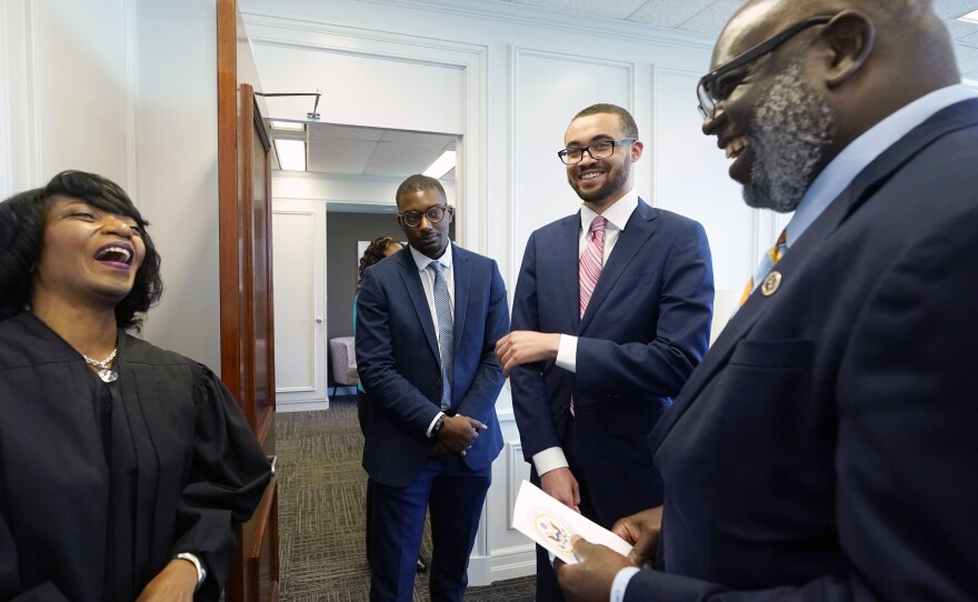 U.S. District Chief Judge Debra M. Brown, left, jokes with District Judge Carlton Reeves for the Southern District of Mississippi, right, his law clerk George Brewster, second from left, and student James Minor, following a "gavel passing ceremony" in Greenville, Miss., Friday, June 11, 2021.