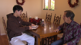 16-year-old Arthur Wang is shown with Jeff Sikking, 83, in Sikking's home on Dec. 31, 2024. Sikking has Alzheimer's Disease.