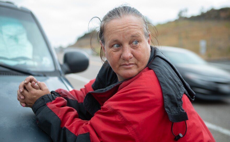 Naomi Flynn sits in her truck on the side of a road in Spring Valley on June 7, 2021. She has been living in her truck since she was forced to leave a county run-hotel.