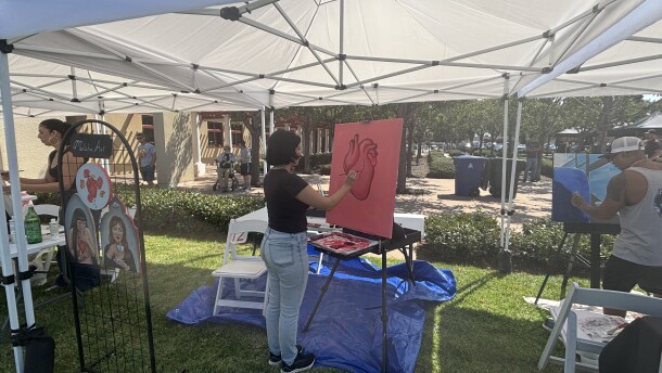 Ariana Arroyo (left), Melissa Salgado (middle), and Vince Alvendia live painting at Chula Vista Art Fest in front of the City Hall on Sept. 27, 2025.