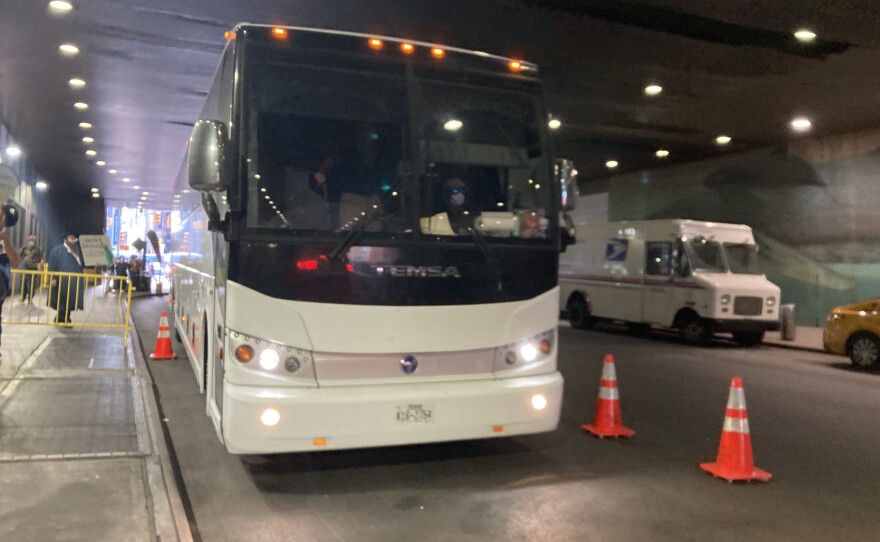 A bus carrying migrants from the Texas border pulls up outside the Port Authority Bus Terminal on Aug. 17.