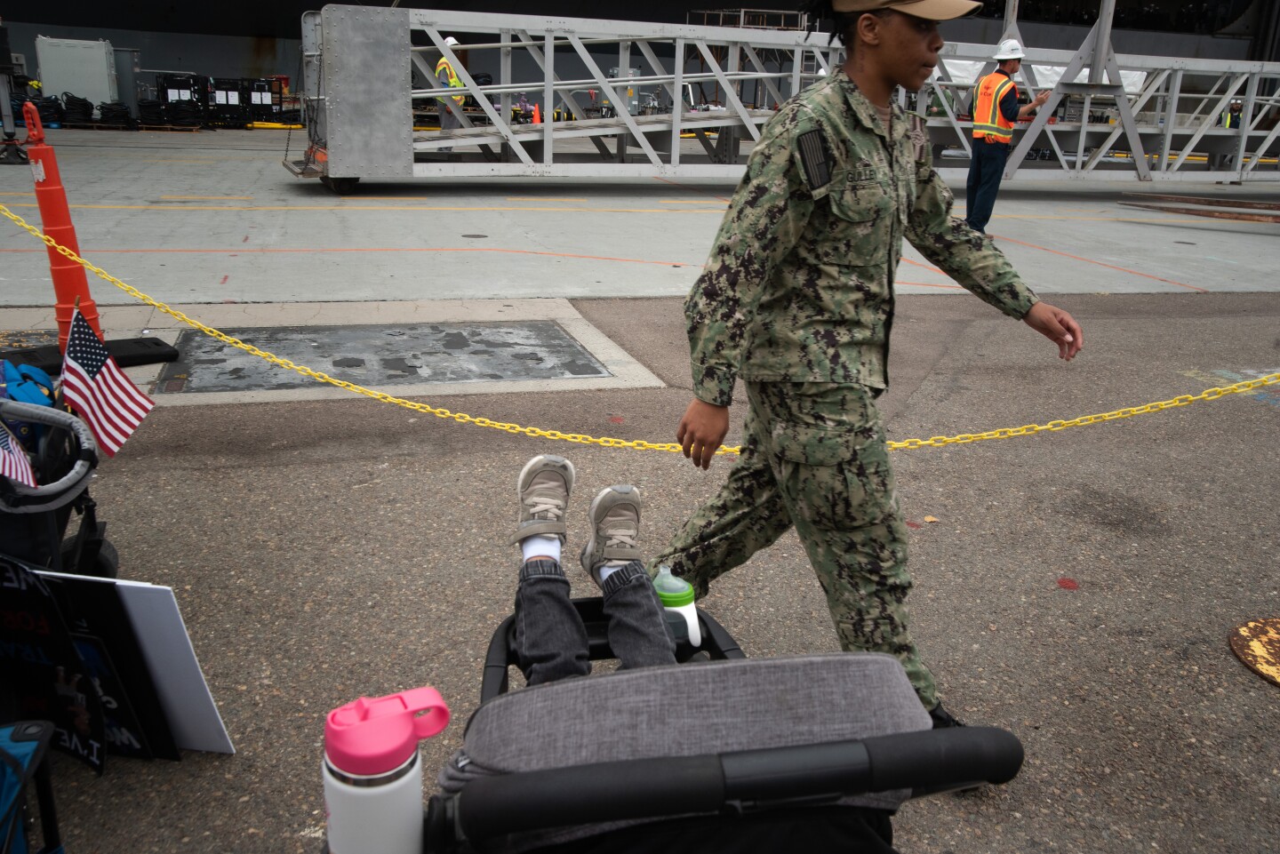 People wait for the sailors aboard the aircraft carrier Theodore Roosevelt to depart on Oct. 15, 2024 at the Naval Air Station North Island on Coronado Island.