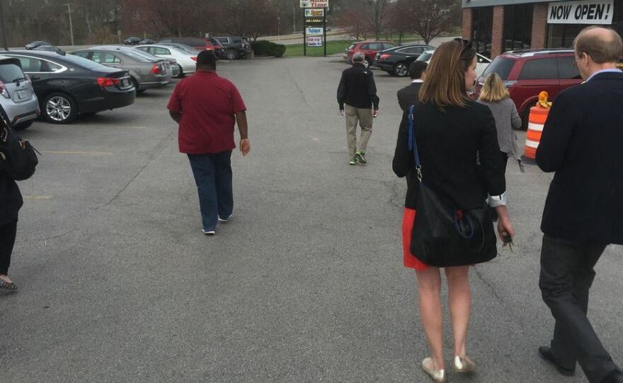 Reporters and campaign staffers rush to their cars to get to Hillary Clinton's first Iowa campaign stop.