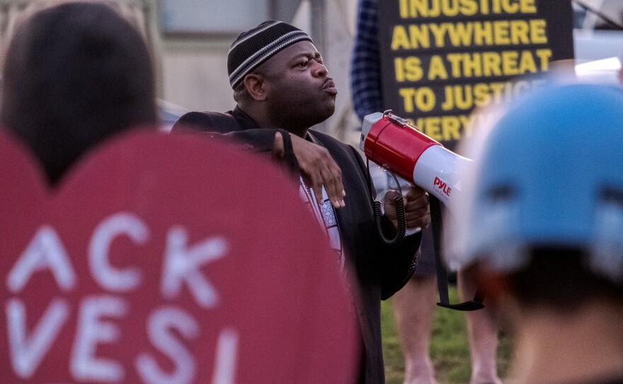 Yusef Miller with the North County Equity and Justice Coalition spoke with protesters in Lakeside, Saturday April 23, 2022.