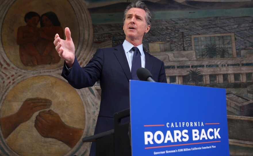 California Gov. Gavin Newsom speaks during a press conference in Oakland, Calif., on Monday where he announced a new round of $600 stimulus checks residents making up to $75,000 a year. Newsom also announced a projected $75.7 billion budget surplus compared to last year's projected $54.3 billion shortfall.