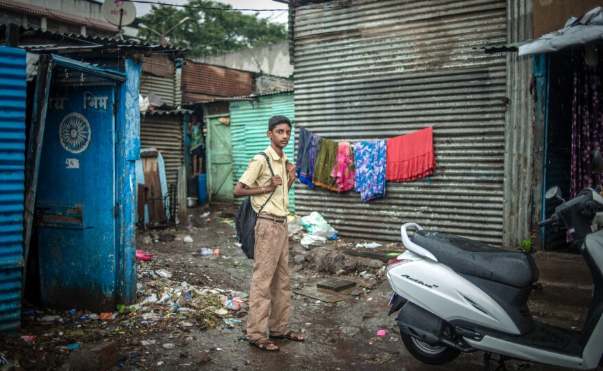 Wearing his school uniform, Aniket heads off to class.