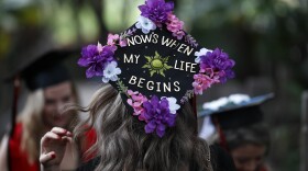 Alison Vargas, center, wears a graduation cap adorned with words and flowers as she takes pictures with fellow San Diego State environmental engineering classmates, Kaitlyn Kirkup, left, and Natalie Rios, right, in Balboa Park, Wednesday, May 15, 2019, in San Diego.


