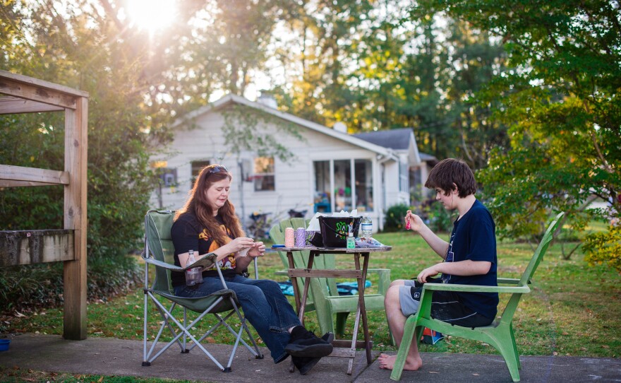 Griffin and her oldest son, Griffin Shade, 13, make Halloween treats outside their home.