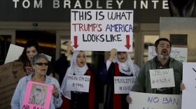 Demonstrators chant outside Tom Bradley International Terminal at the Los Angeles International Airport during a protest by airport service workers from United Service Workers West union Monday, Jan. 30, 2017. 