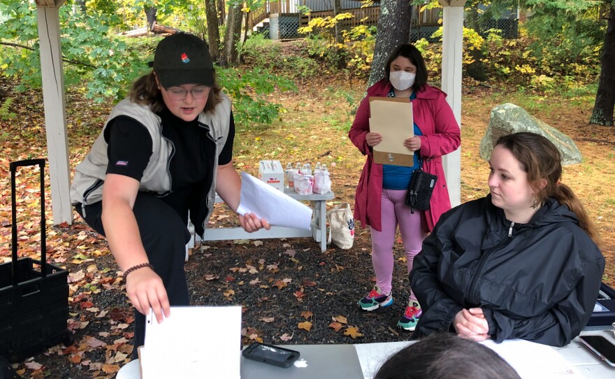 Planned Parenthood organizer Katie McClelland (L) gives a pep talk to volunteers outside the library in Windham, Maine, on Oct. 16. The volunteers then fan out to different neighborhoods to engage in "deep canvassing" The goal is to have four conversations with voters over the next two hours.