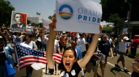 (File photo) Gay pride participants hold signs in support of Democratic presidential hopeful Barack Obama at the 38th annual LA Pride Parade June 8, 2008 in West Hollywood, California. 