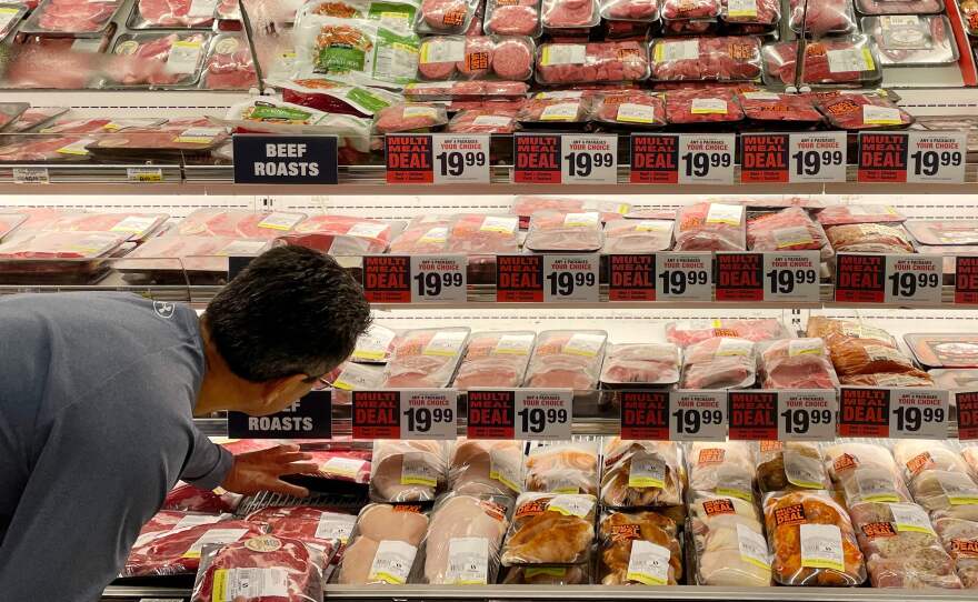 A man shops for meat at a grocery store in Annapolis, Md., on May 16 as Americans brace for summer sticker shock because of high inflation.