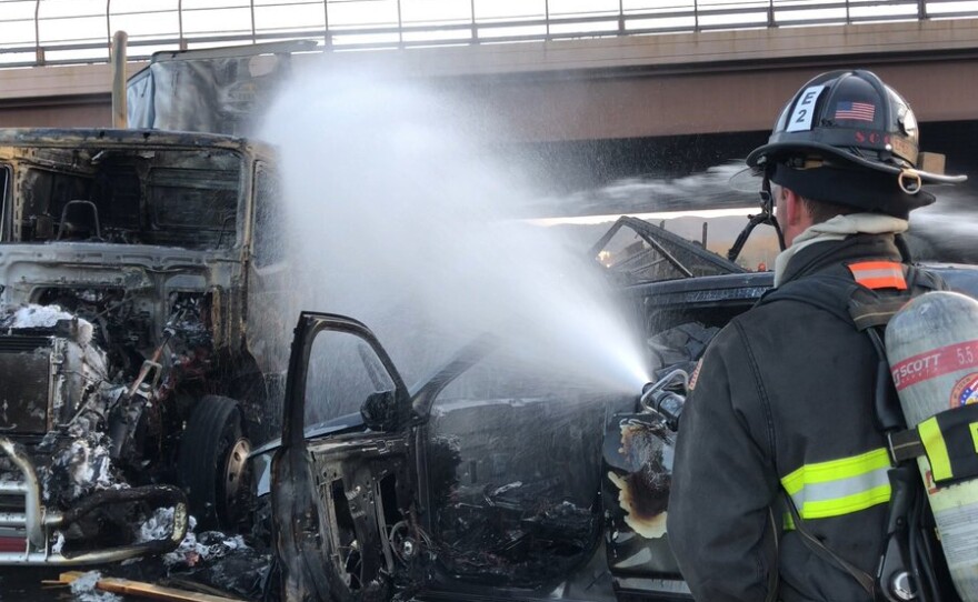 This April 25, 2019 file photo provided by West Metro Fire Rescue shows a firefighter working the scene of a deadly pileup involving over two dozen vehicles near Denver. Truck driver Rogel Lazaro Aguilera-Mederos, 26, has been sentenced to 110 years in prison for causing the accident.